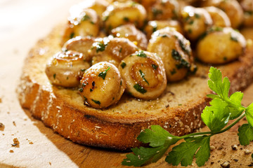 Bruschetta with aromatic fried  mushrooms, garlic and parsley