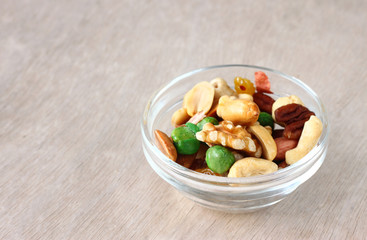 Assorted healthy mixed nuts on wooden textured background  