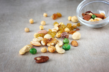 Assorted healthy mixed nuts on wooden textured background  