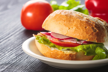 Sliced ham sandwich with tomatoes on a mixed seed bread