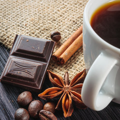 Cup of coffee with brown sugar on a wooden table.