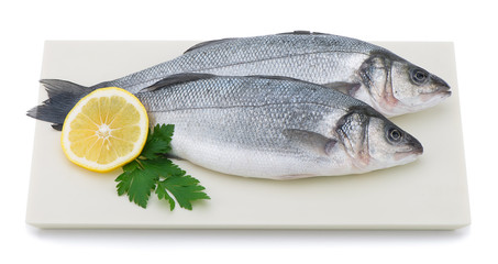 Fresh sea bass on plate isolated on white background