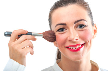 Attractive pretty smiling woman applying make up