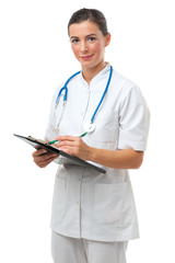 Attractive woman doctor writing on clipboard