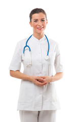 Attractive young woman doctor with stethoscope standing over whi
