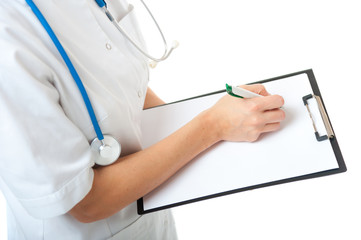 Female doctor with stethoscope writing on blank clipboard