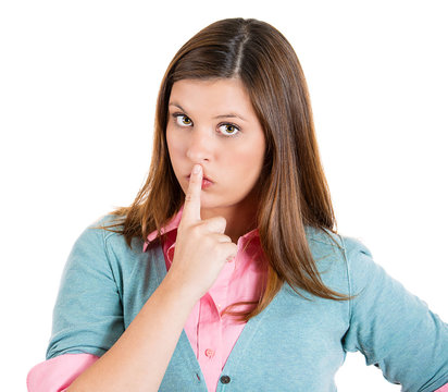 Secret woman with finger on lips gesture on white background 
