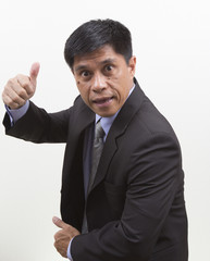 Businessman gesturing thumbs up sign