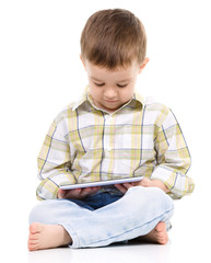 Young boy is using tablet