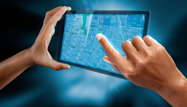A woman use a tablet phone to check a city map