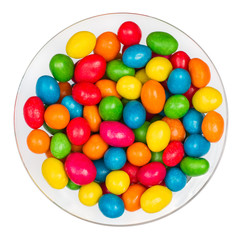 Transparent glass full of sweet candy against white background