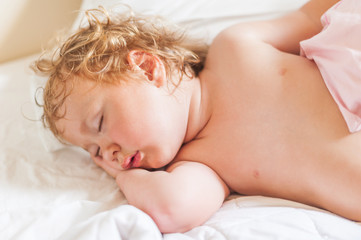 Obraz na płótnie Canvas Sleeping cute baby toddler in bed