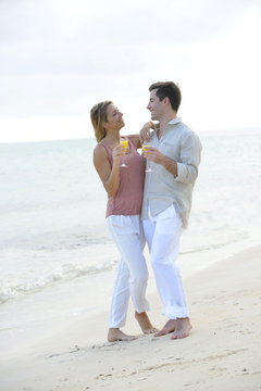 Couple enjoying cocktail on caribbean beach