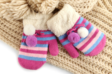 Fototapeta na wymiar Striped mittens with scarf close up