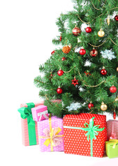 Decorated Christmas tree with gifts isolated on white