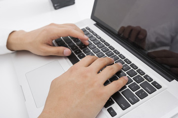 Fototapeta na wymiar Businessman's hands using laptop