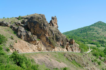 Fototapeta na wymiar landscape with rocks hill and clear blue sky over the road