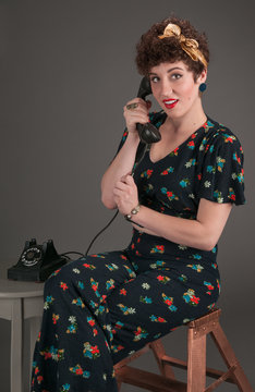 Pinup Girl in Flowered Outfit on The Phone Looks Surprised