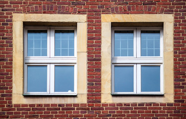 Fototapeta na wymiar Windows of an old brick house