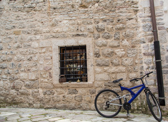 Fototapeta na wymiar Blue Bike on Old Stone Wall