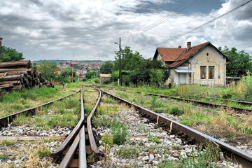 Fototapeta na wymiar A view of the railway tracks leading with an old house station