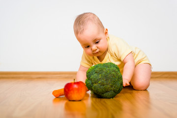Fototapeta premium Baby eating fruits and vegetables
