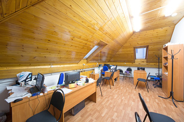 Office room with wooden ceiling in the attic