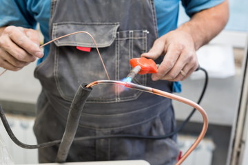 Worker air conditioner pipe welds oxyfuel gas welding