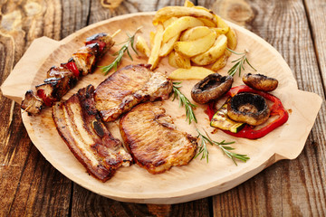 Fried pork meat with wedges potatoes  and grilled vegetables