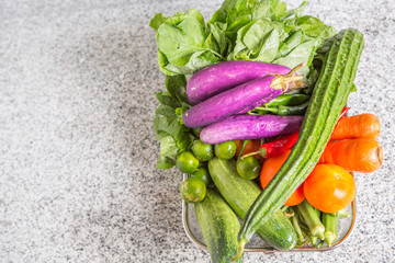 Mix tropical vegetables on a kitchen granite surface counter