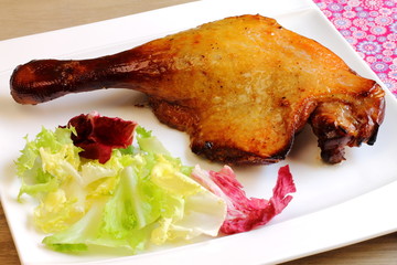 Duck leg with salad. Confit de canard