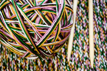 Great ball of colored yarn, wooden knitting needles