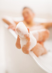 Fototapeta premium Closeup on legs of young woman in bathtub