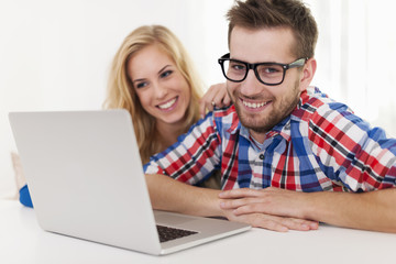 Portrait of smiling couple with laptop