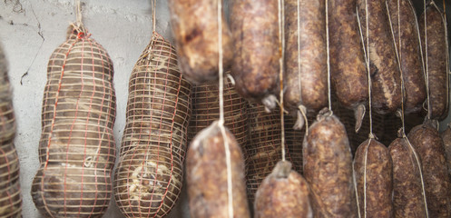 Salami Italian handmade hanging to mature in the cellar