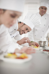 Fototapeta na wymiar Team of chefs preparing delicatessen dishes