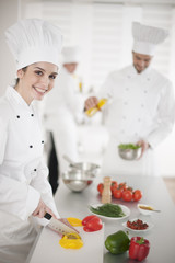 kitchen team at work female chef at foreground