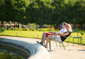 Couple relaxing in the Tuileries garden of Paris