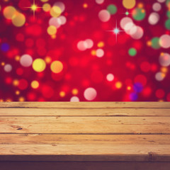 Empty wooden deck table over festive bokeh background