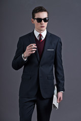 Retro fifties fashion young businessman with black sunglasses we