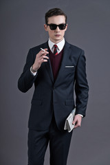 Retro fifties fashion young businessman with black sunglasses we