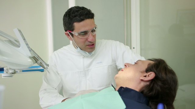Dentist visiting patient in dental studio