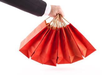 Man holding red shopping bags on white background