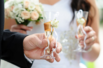 Bride and groom holding glasses of champagne