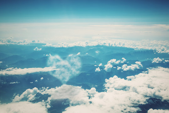 Heart Shaped Cloud On Blue Sunny Sky.