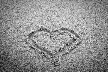 Heart shape on sand. Romantic, black and white