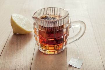 Glass cup of tea with lemon