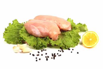 Chicken breasts on lettuces leaves isolated over white
