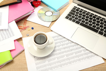 Fototapeta na wymiar Cup of coffee on office desktop close-up
