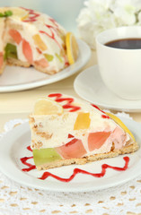 Delicious jelly cake on table on light background